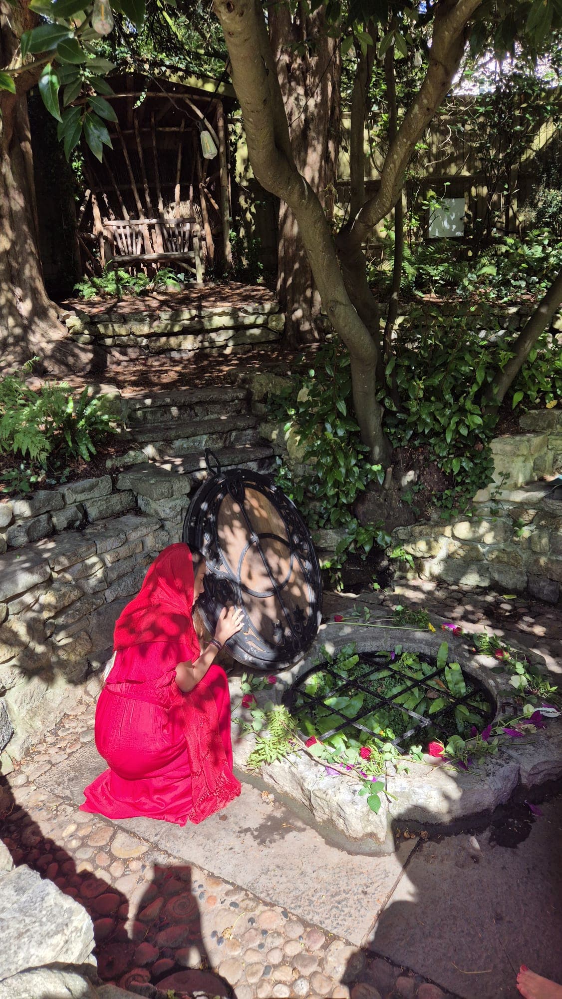 Sacred ceremony at ancient stone well with ceremonial drum